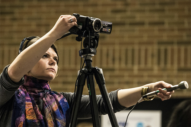 Woman filming with microphone